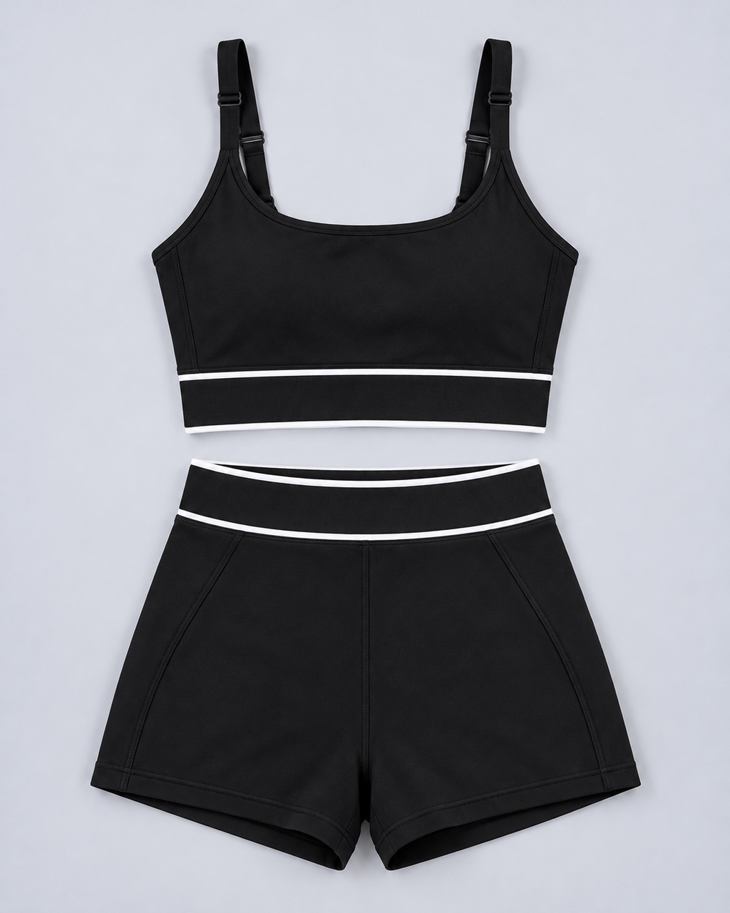 Tempo Set in Black, flat lay of sports bra and shorts with white stripes