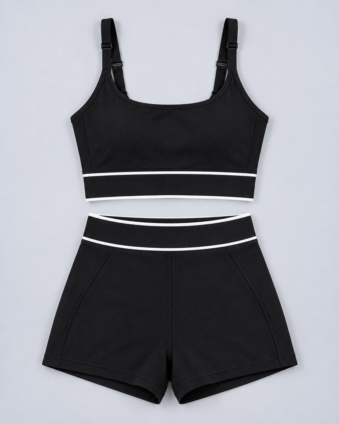 Tempo Set in Black, flat lay of sports bra and shorts with white stripes