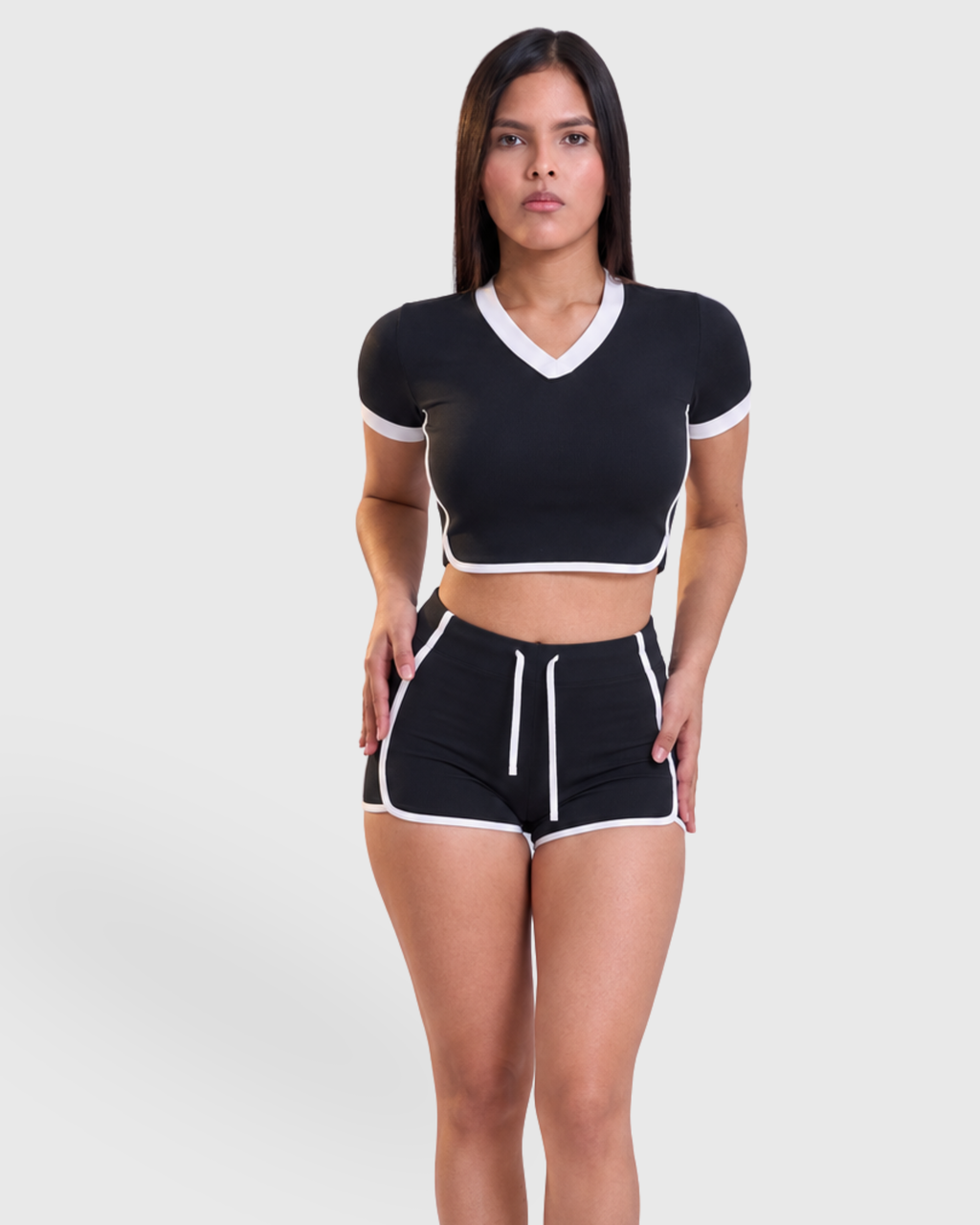 Rally Set in Black, front view of V-neck crop top and shorts with white trim