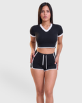 Rally Set in Black, front view of V-neck crop top and shorts with white trim