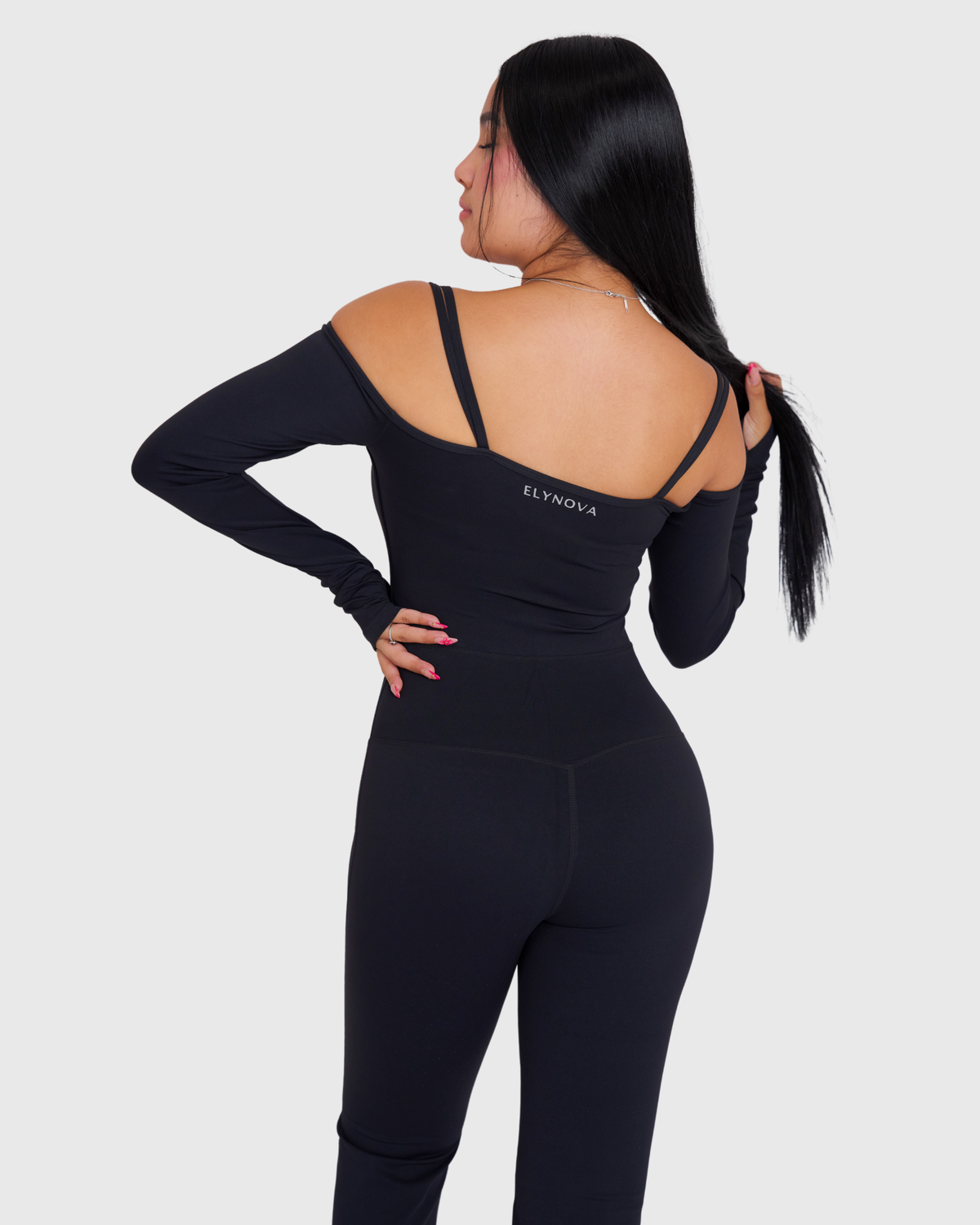 Off-Shoulder Flare Jumpsuit in Black, back view of straps and ELYNOVA logo