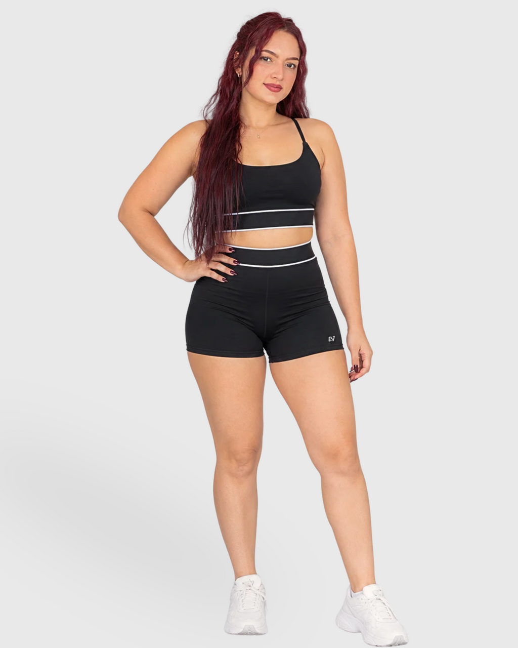 Tempo Set in Black, front view of sports bra and shorts with white stripes