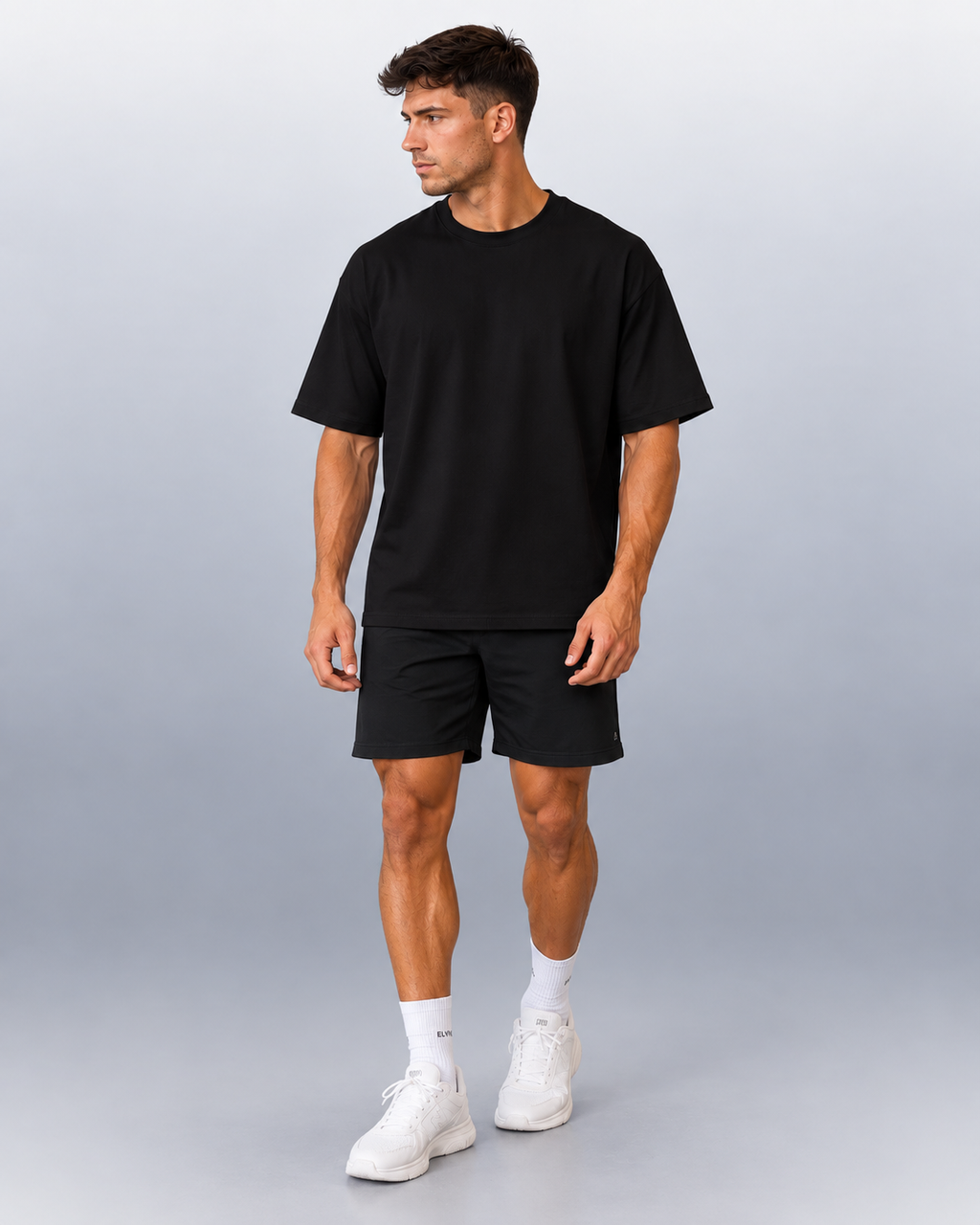Oversized Tee in Black, full-body front view on a male model