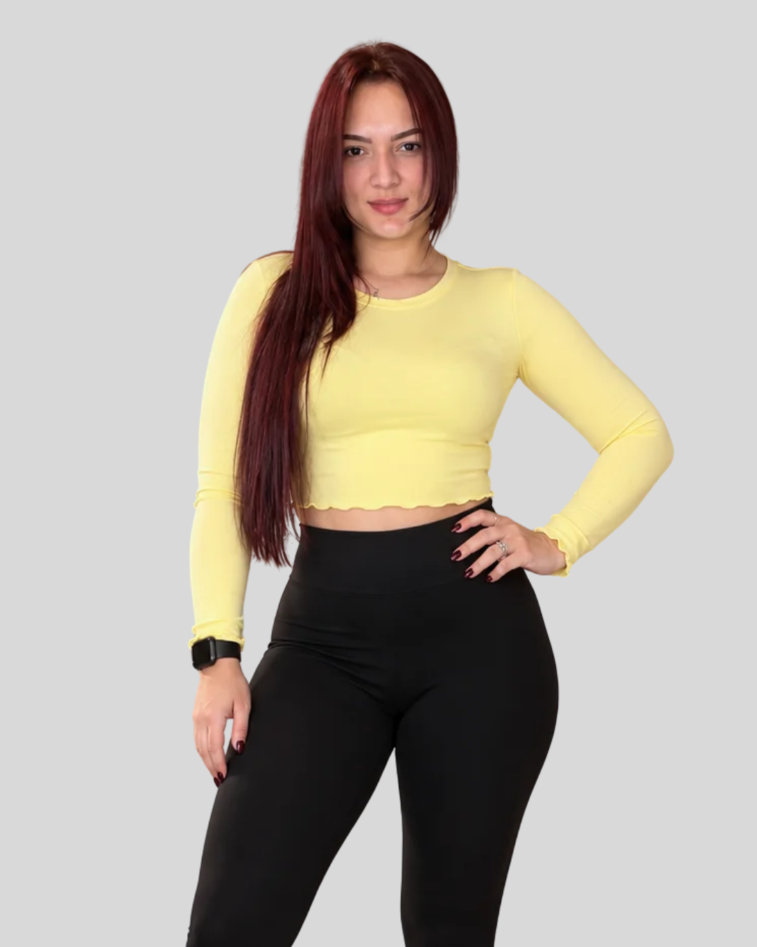 Aura Top in yellow, front view of long-sleeve crop top with black leggings